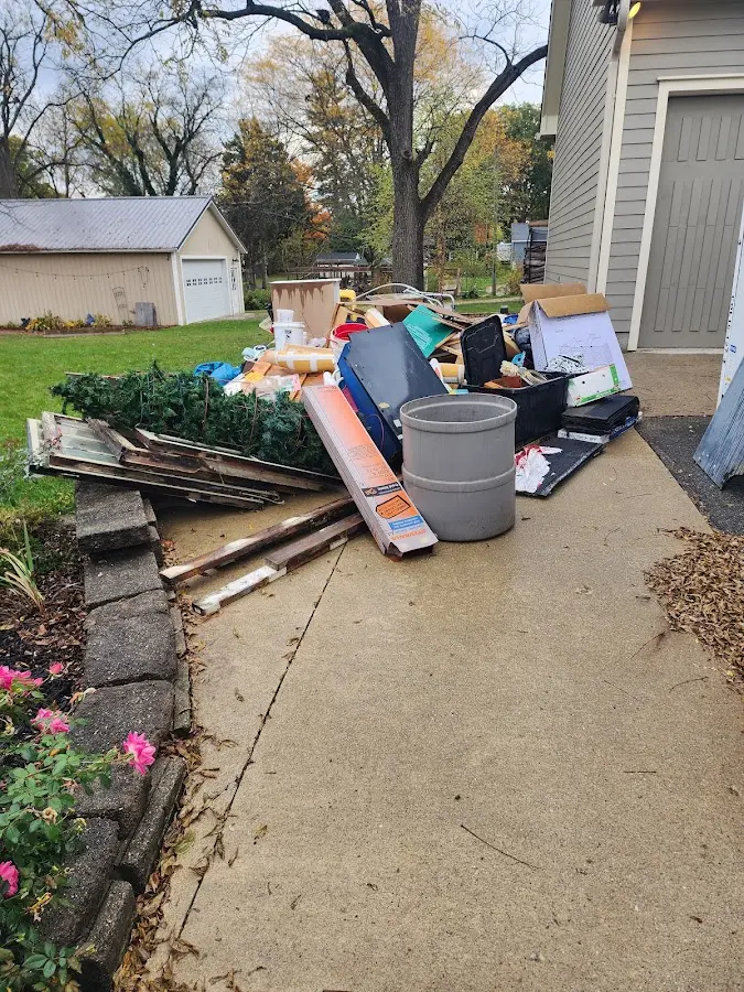 Dumpster being loaded with debris for 10 Yard Dumpster Rental in Three Rivers